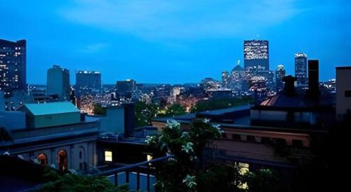 a view of a city skyline at night at Fifteen Beacon Hotel in Boston