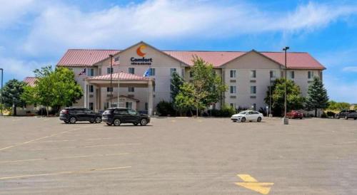 a large building with cars parked in a parking lot at Comfort Inn & Suites in Riverton
