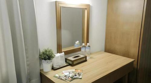 a bathroom with a wooden counter with a mirror at Urban House 195 in Chiang Mai