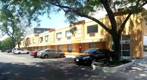 a parking lot with cars parked in front of a building at Chicago Lake Shore Hotel in Chicago