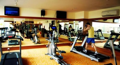 a man on a cell phone in a gym at The BCC Hotel & Residence in Nagoya