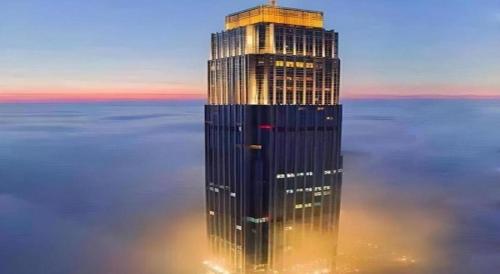 a tall skyscraper in the middle of the water at AOLUGUYA in Harbin