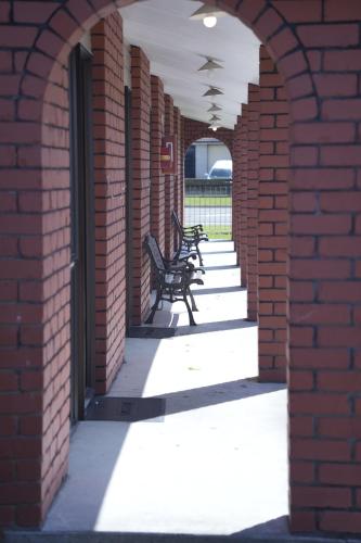 an archway with benches in a brick building at Accommodation Gateway Motel in Palmerston North