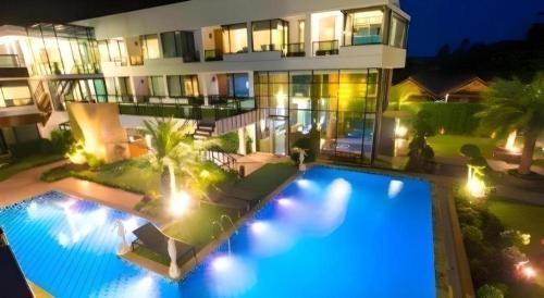 an aerial view of a building with a swimming pool at night at Phi Phi Nice Beach Hotel Hip in Phi Phi Don