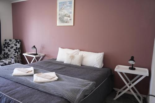 a bedroom with a bed with two towels on it at Accommodation Gateway Motel in Palmerston North