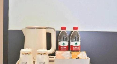 two bottles of soda sitting next to a blender at Jinjiang Inn Changchun Xi An Avenue Branch in Changchun