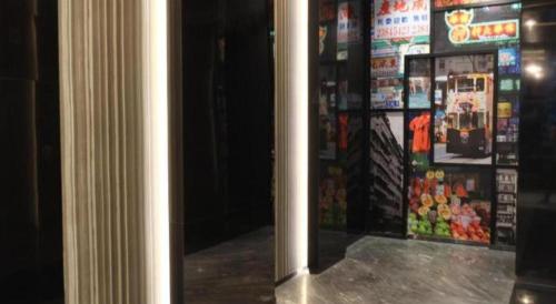 a door to a store with posters on the wall at M1 North Point Hotel in Hong Kong