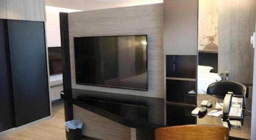 a room with a flat screen tv on a wall at M1 North Point Hotel in Hong Kong