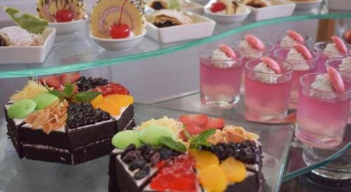 a table topped with different types of desserts at Bogor Valley Hotel in Bogor
