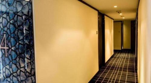 a hallway of a building with a tile floor at Noble Park Hotel in Hong Kong