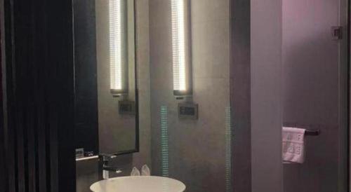 a bathroom with a sink and a mirror at H Life Hotel Nanshan Branch in Shenzhen