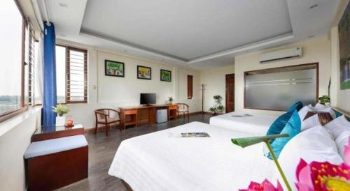a large room with a bed and a desk at Viet Village Hotel in Hanoi
