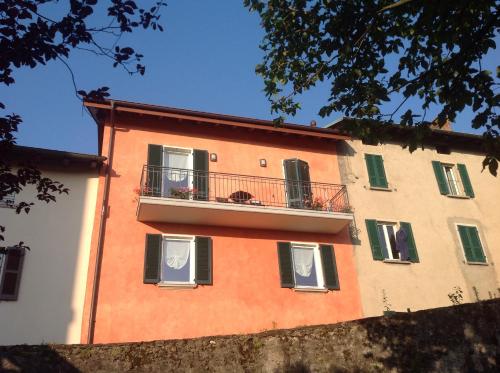 un edificio arancione e bianco con balcone di Appartamento TieMi a Coldrerio