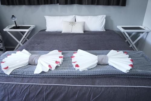 a bed with two pillows shaped like wings at Accommodation Gateway Motel in Palmerston North