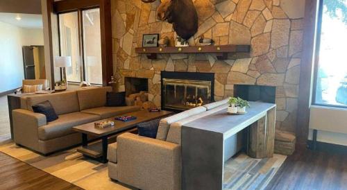 a living room with a couch and a fireplace at Best Western Lake Lucille Inn in Wasilla