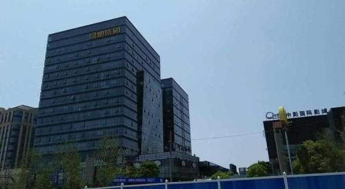 a tall building with a sign on the side of it at Jinjiang Inn Select Shanghai International Tourism and Resorts Zone Chuansha Road Subway Station in Shanghai