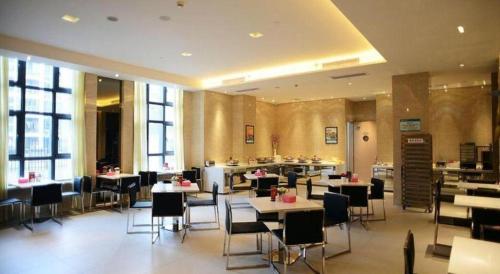 a dining room with tables and chairs in a restaurant at Jinjiang Inn Select Shanghai International Tourism and Resorts Zone Chuansha Road Subway Station in Shanghai