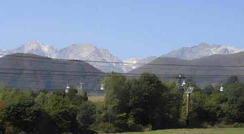 a view of a mountain range with trees and power lines at Espoir Misawa in Hakuba
