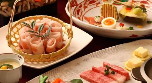 a table with three plates of food on it at Hotel Myoken Tanaka Kaikan in Kirishima