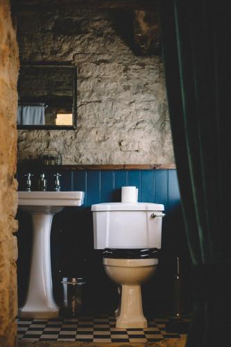 a bathroom with a toilet and a sink at The Stag at Stow in Stow on the Wold