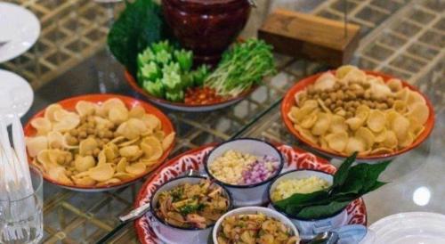 a table with four bowls of food on a table at The Buffalo Amphawa in Samut Songkhram