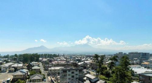 a view of a city with mountains in the background at Ou Hotel in Yonago