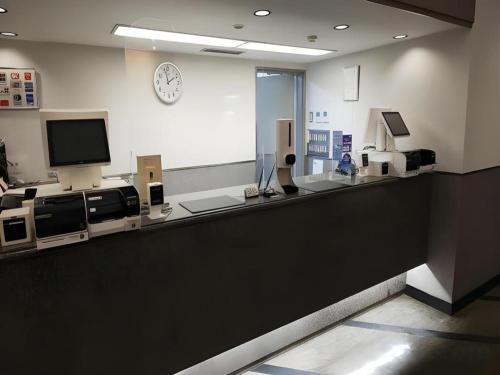 a waiting room with a counter with a tv at Alpha Hotel Tokushima in Tokushima