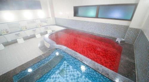 a pool of red water in a bathroom at Hotel Naito Kofu Showa in Kofu