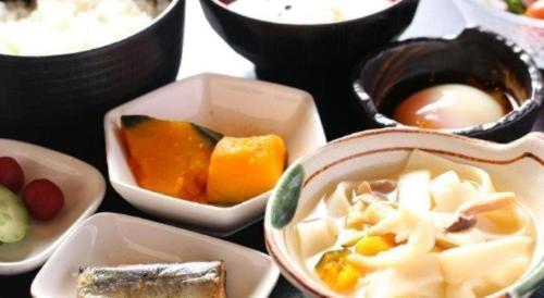 a group of bowls of food on a table at Hotel Naito Kofu Showa in Kofu