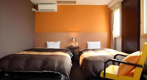 Una cama o camas en una habitación de Hotel 1-2-3 Kofu Shingen Onsen
