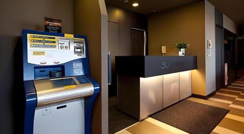 a room with a atm machine in a room at Super Hotel Arai-Niigata in Myoko