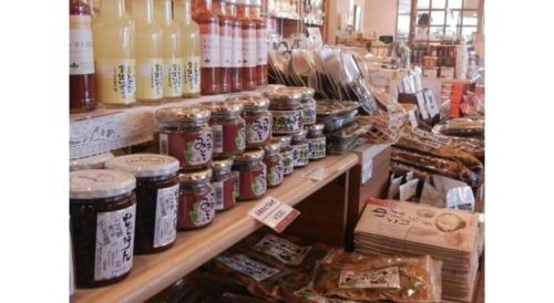 a store filled with lots of jars of food at Kyoto Keburikawa Hotel in Kameoka