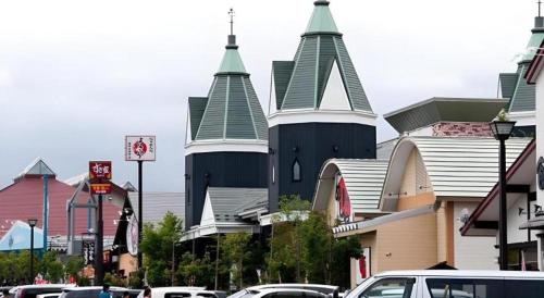 a large church with towers on a city street at Super Hotel Arai-Niigata in Myoko