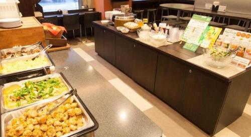 a buffet line in a restaurant with some food at Super Hotel Arai-Niigata in Myoko