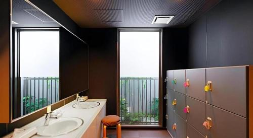 a bathroom with two sinks and a large mirror at Super Hotel Arai-Niigata in Myoko