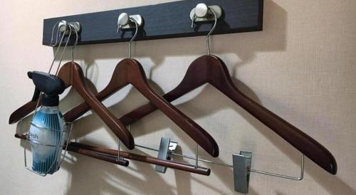 a group of wooden hangers hanging on a wall at AI HOTEL OYAMA in Sano