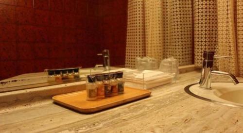 a bathroom counter with a sink and a mirror at Gunma Royal Hotel in Maebashi