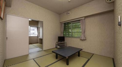 a living room with a table and a window at Hotel Alphastar Iwappara in Yuzawa