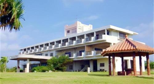 a large building with a gazebo in front of it at Hotel Thida No Sato in Miyako Island