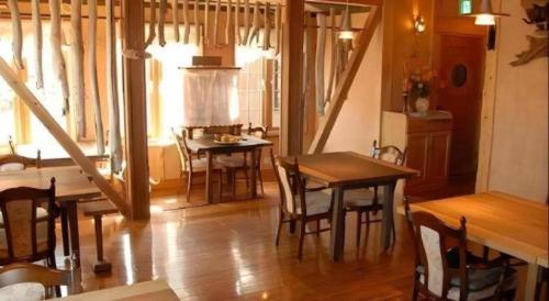 a dining room with a table and some chairs at Auberge Kitano Dandan in Abashiri