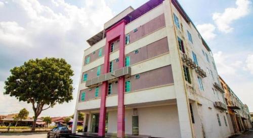 a building with pink columns on the side of it at e Hotel in Melaka