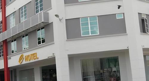 two sides of a white building with windows at e Hotel in Melaka