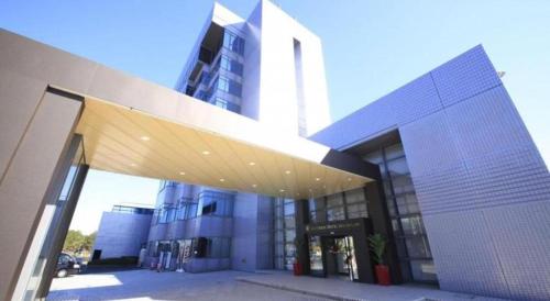 a large building with awning in front of it at Centurion Hotel Technoport Fukui- Artificial Radium Hot Spring in Sakai