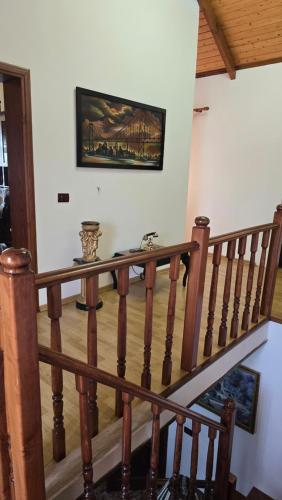 a wooden staircase with a painting on the wall at Eni's Villa in Lezhë