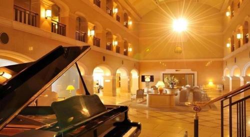 a large lobby with a piano and a living room at Hotel de Premiere Minowa in Inawashiro
