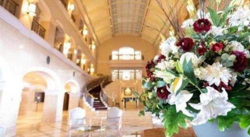 a large vase filled with flowers in a building at Hotel de Premiere Minowa in Inawashiro