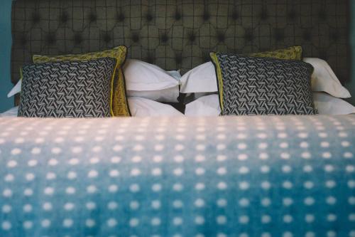 a close up of a bed with pillows at The Stag at Stow in Stow on the Wold