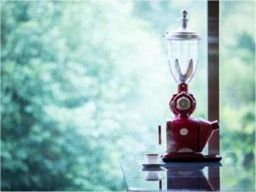 a red bird feeder with a light on a window at Yufuin Onsen Yufuin Nanairo no Kaze in Yufuin