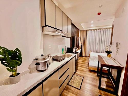 バギオにあるCondotel Near SM Baguio, Cathedral & Session Rd by Le Chateau Baguioのキッチン(カウンター付)、リビングルーム
