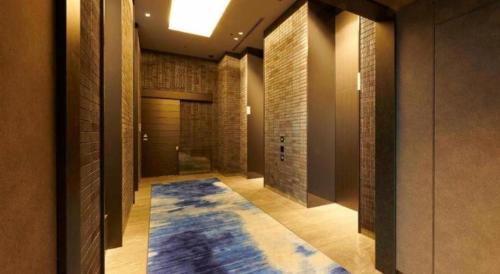 a hallway with a blue rug on the floor at HOTEL CLAD in Fuji